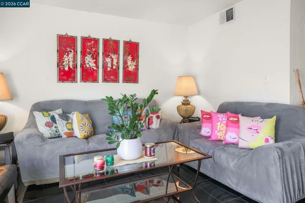 a living room with furniture and flowers