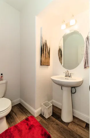 a bathroom with a sink toilet and mirror