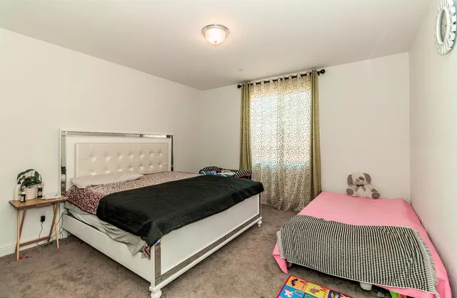 a bedroom with a bed and window