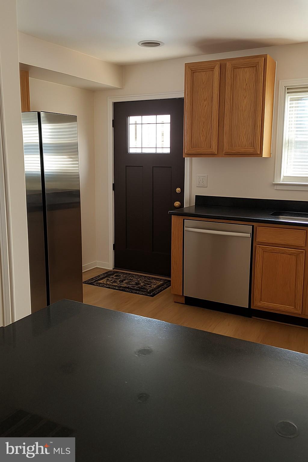 22 West 7th Street Frederick, MD 21701 - Photo 3 of 12 a kitchen with stainless steel appliances granite countertop a refrigerator and a sink