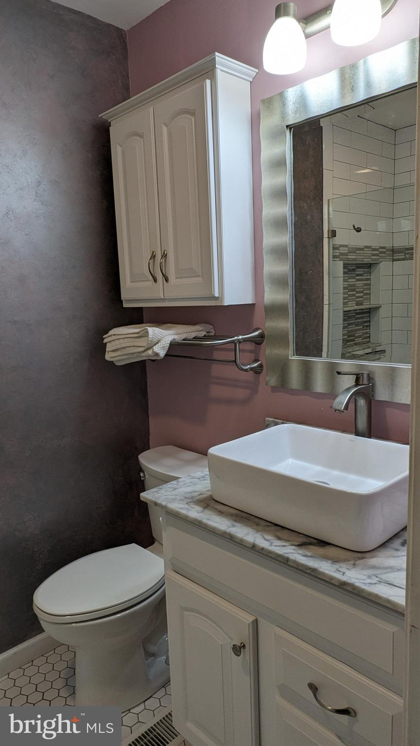 22 West 7th Street Frederick, MD 21701 - Photo 9 of 12 a bathroom with a granite countertop toilet sink and mirror