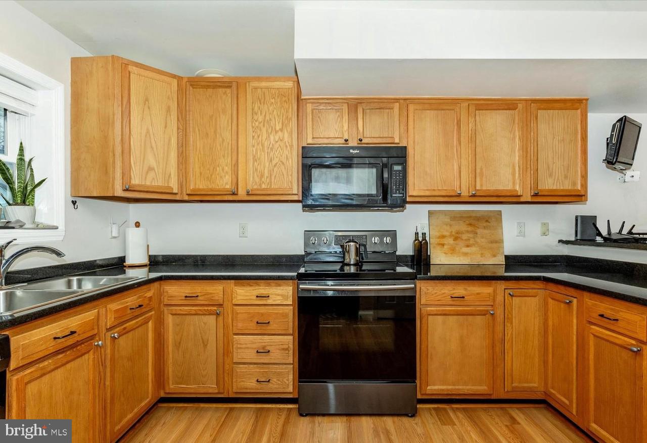 22 West 7th Street Frederick, MD 21701 - Photo 10 of 12 a kitchen with stainless steel appliances granite countertop a sink stove and microwave