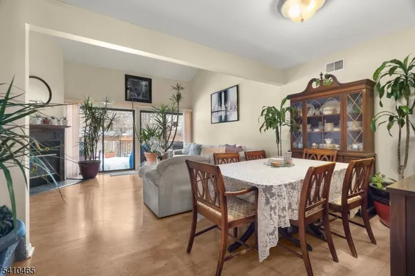 a view of a dining room with furniture and a chandelier
