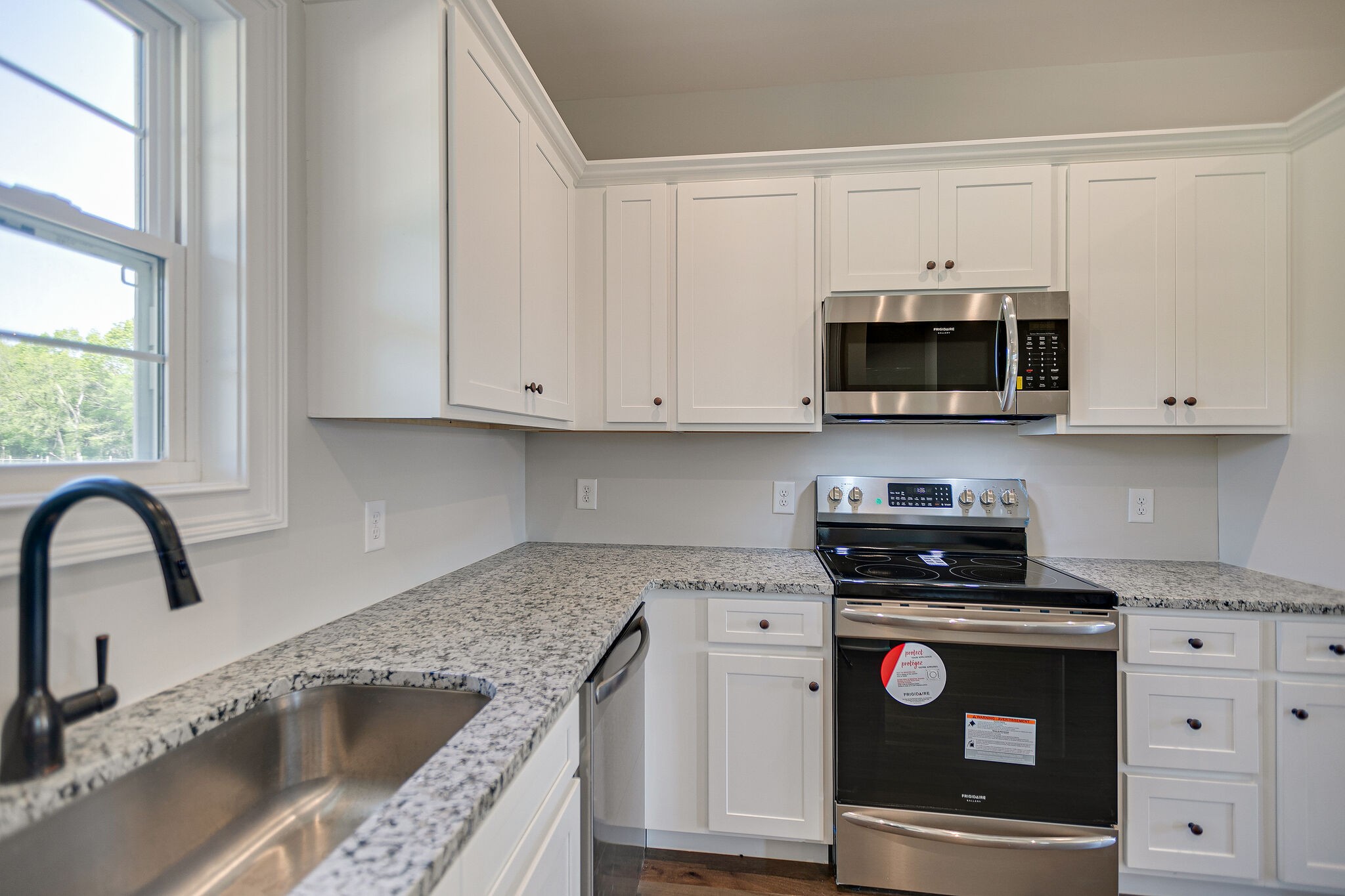 4640 Lunns Store Road Chapel Hill, TN 37034 - Photo 13 of 30 a kitchen with stainless steel appliances granite countertop a stove a microwave and cabinets