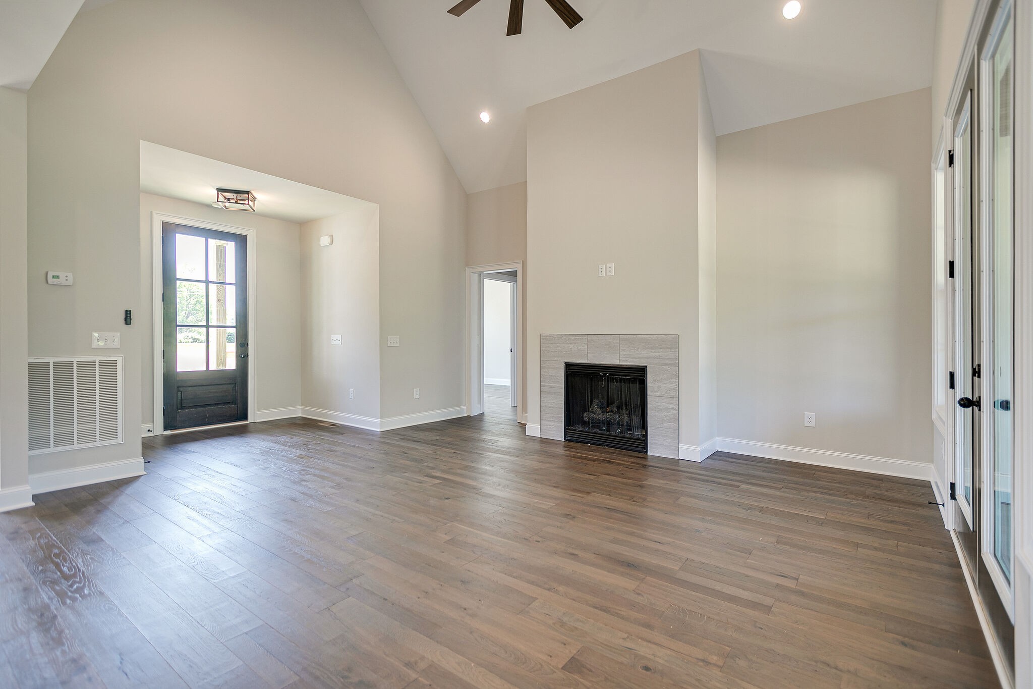 4640 Lunns Store Road Chapel Hill, TN 37034 - Photo 8 of 30 an empty room with wooden floor fireplace and staircase