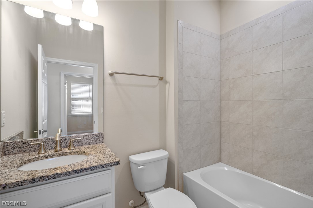 4443 Dutchess Park Road Fort Myers, FL 33916 - Photo 14 of 19 a bathroom with a granite countertop sink mirror vanity and toilet