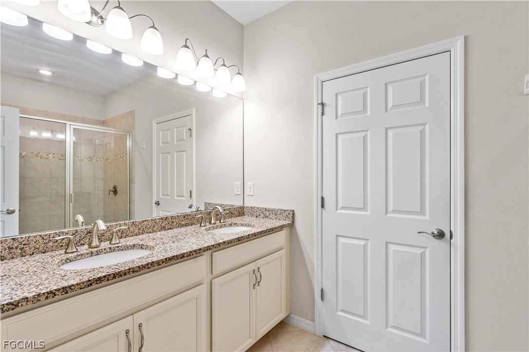4443 Dutchess Park Road Fort Myers, FL 33916 - Photo 19 of 19 a bathroom with a granite countertop double vanity sink a vanity and a mirror