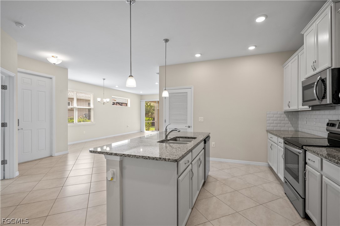 4443 Dutchess Park Road Fort Myers, FL 33916 - Photo 9 of 19 a kitchen with stainless steel appliances granite countertop a sink and a stove