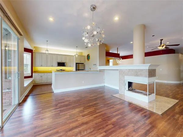 a view of a dining room with furniture and chandelier