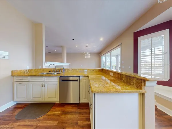a kitchen with stainless steel appliances granite countertop a refrigerator sink and stove