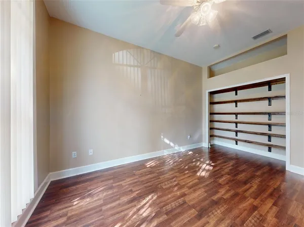 a bedroom with bed and a book shelf