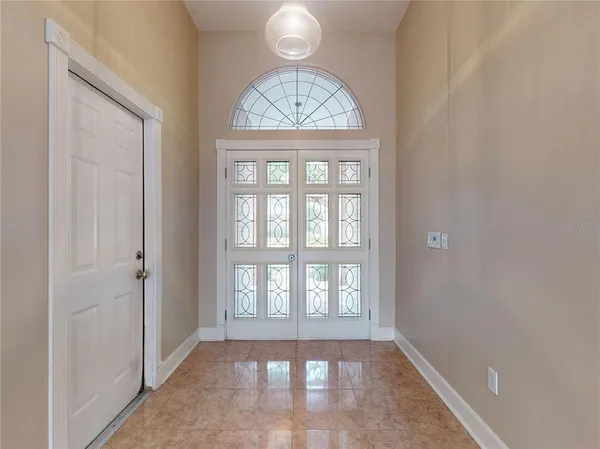 a view of a room with wooden floor and a ceiling fan