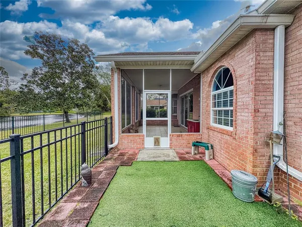 a view of a yard with wooden fence