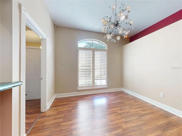 a dining room with furniture a rug and wooden floor