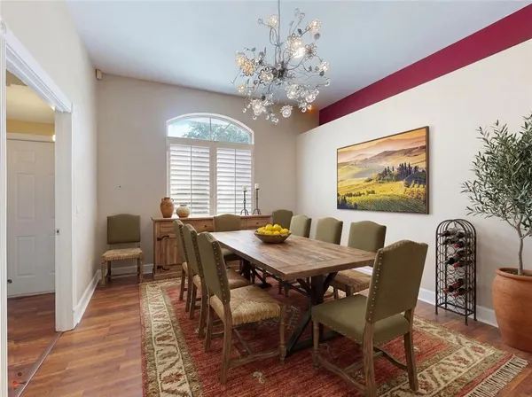 a view of a room with wooden floor and chandelier