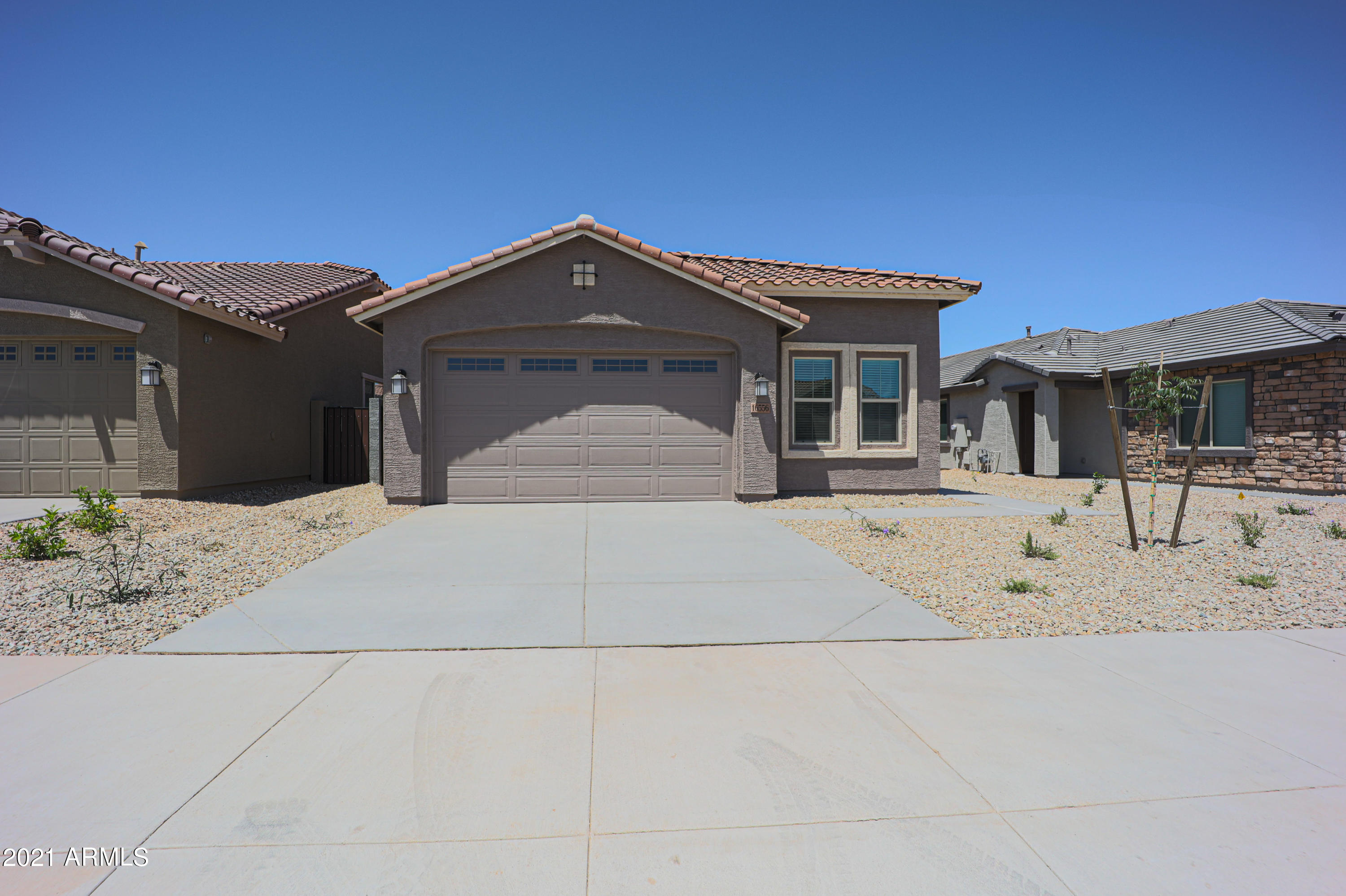 16556 West Alameda Road Surprise, AZ 85387 - Photo 1 of 34 a front view of a house with a yard
