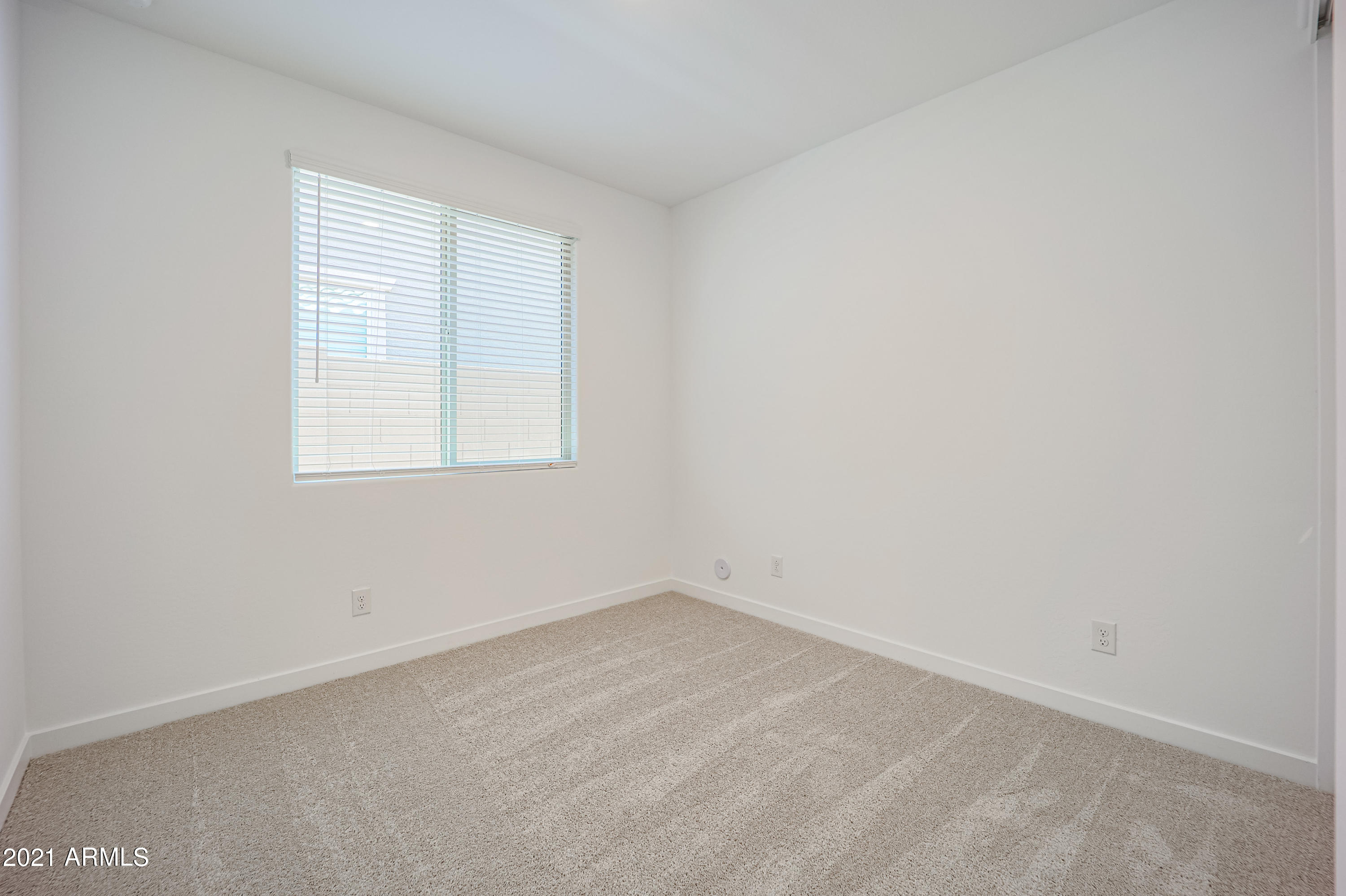 16556 West Alameda Road Surprise, AZ 85387 - Photo 21 of 34 an empty room with a window