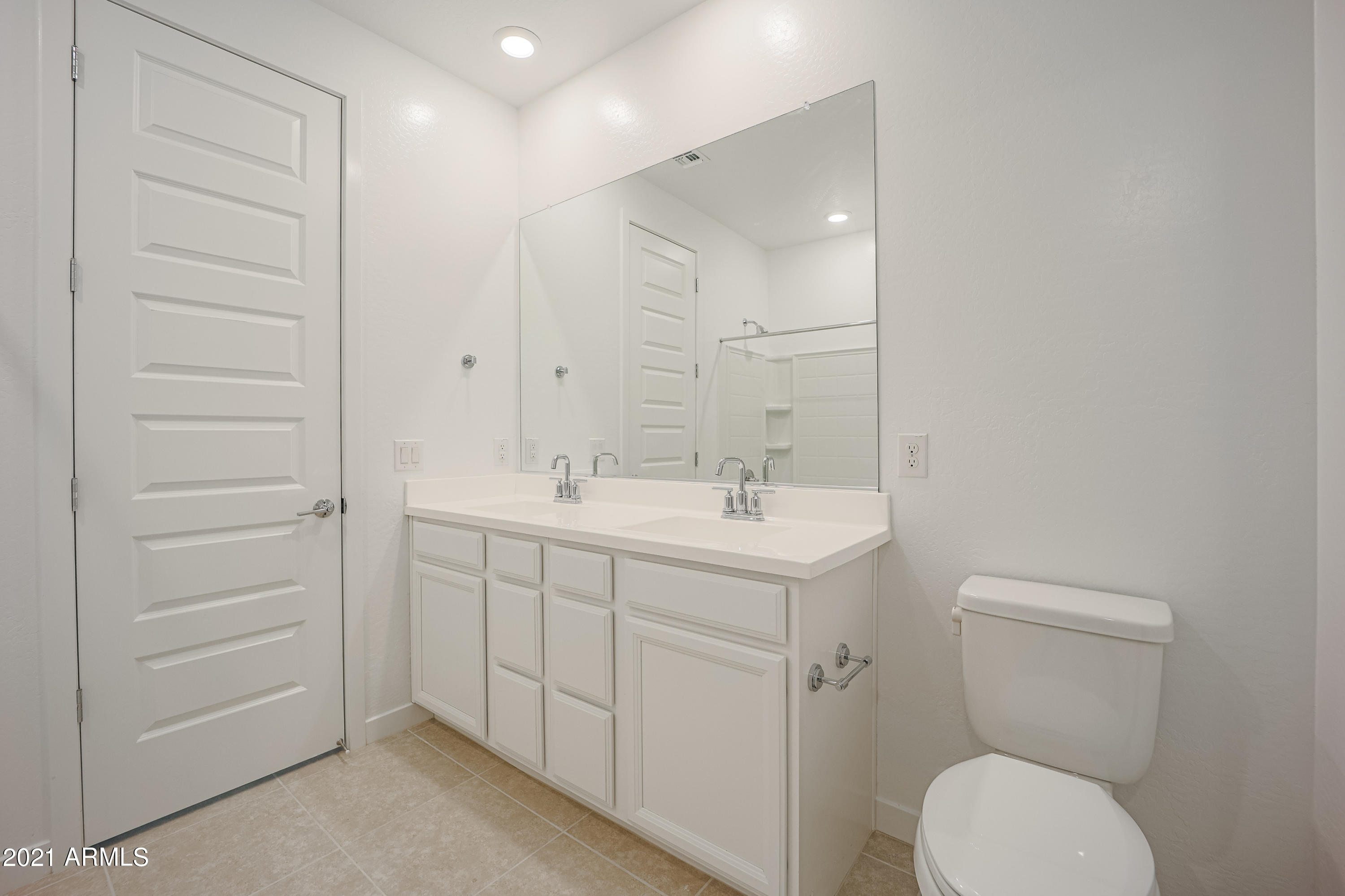 16556 West Alameda Road Surprise, AZ 85387 - Photo 23 of 34 a bathroom with a toilet sink and mirror