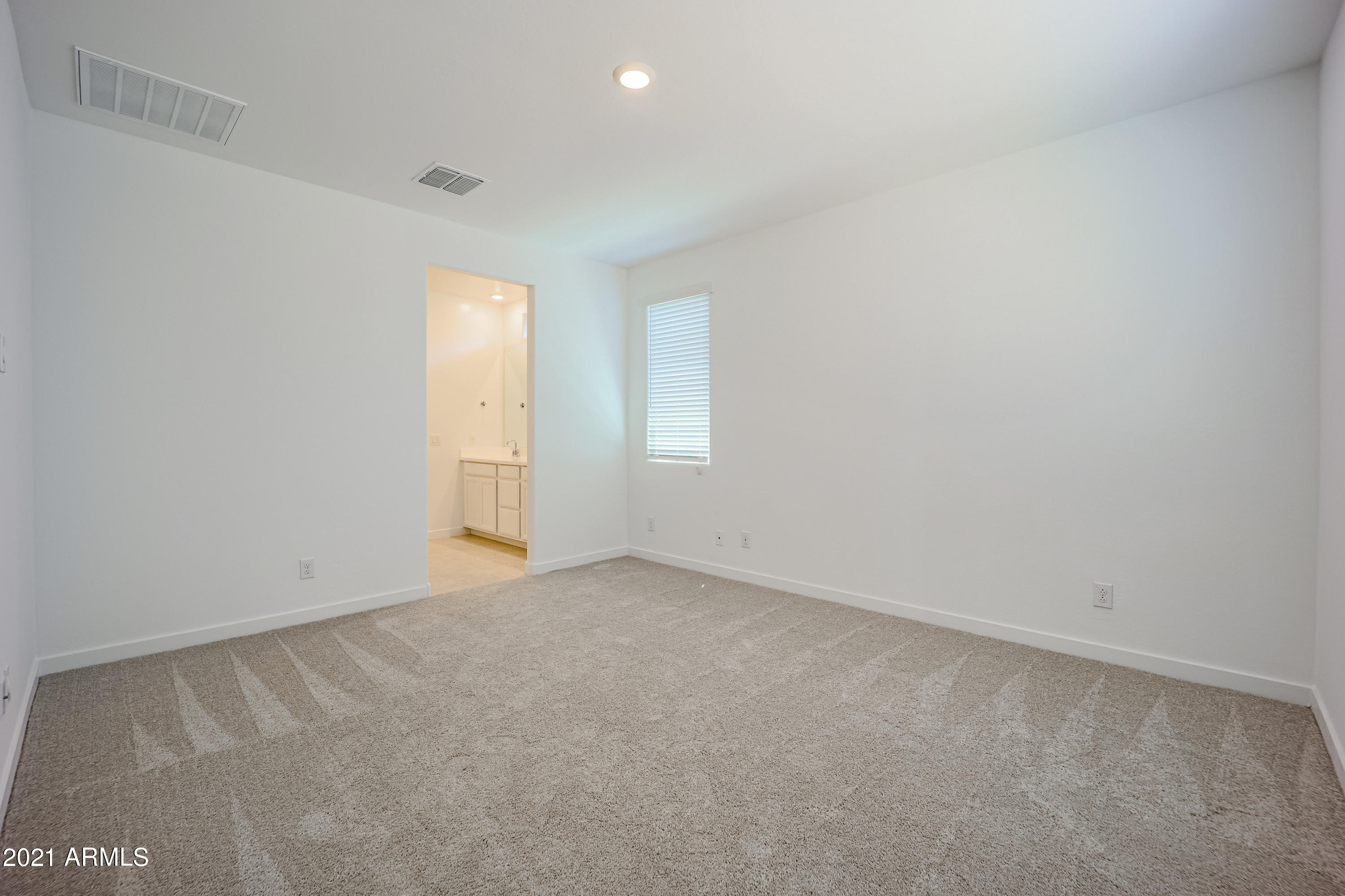 16556 West Alameda Road Surprise, AZ 85387 - Photo 25 of 34 an empty room with windows