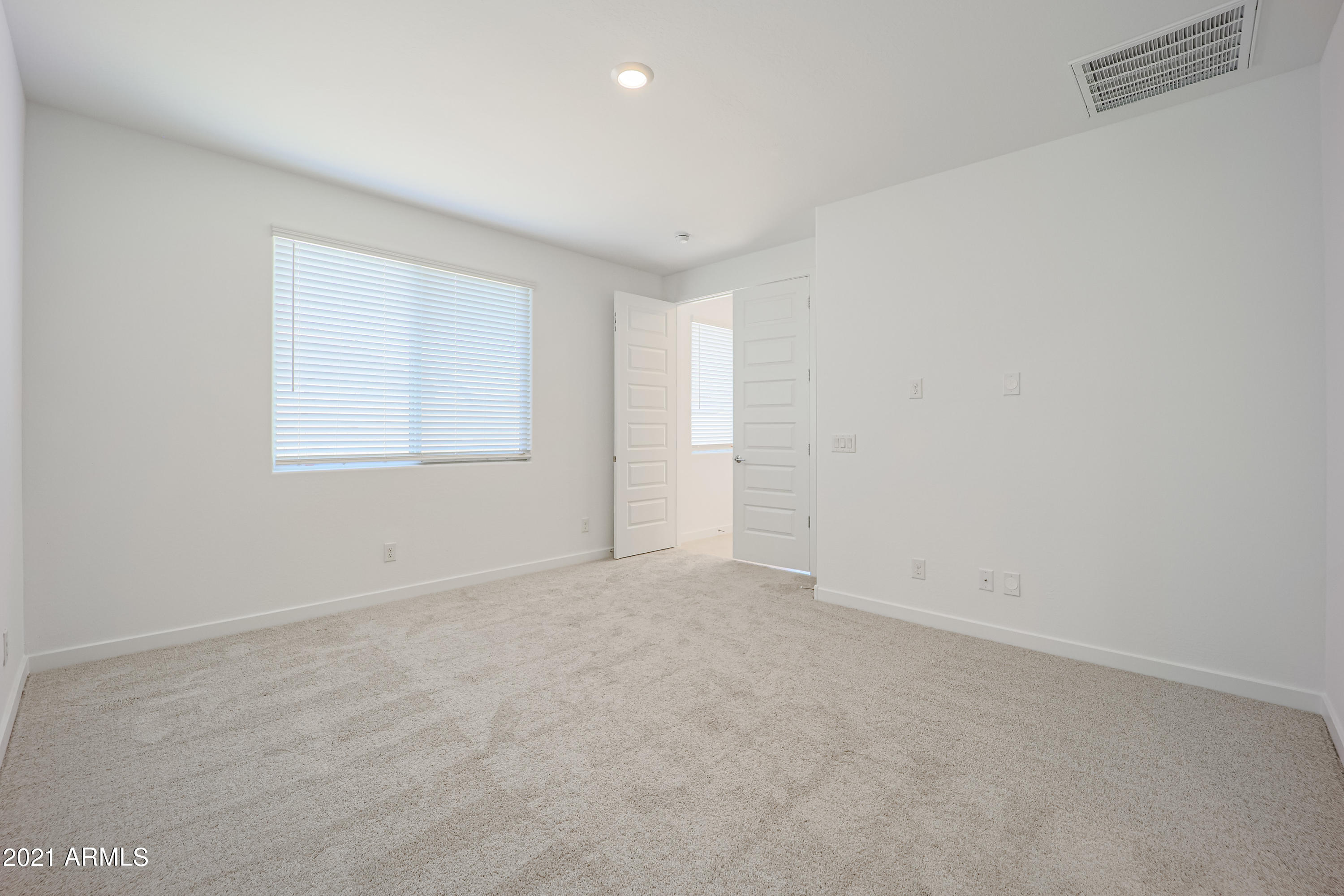 16556 West Alameda Road Surprise, AZ 85387 - Photo 27 of 34 an empty room with a window