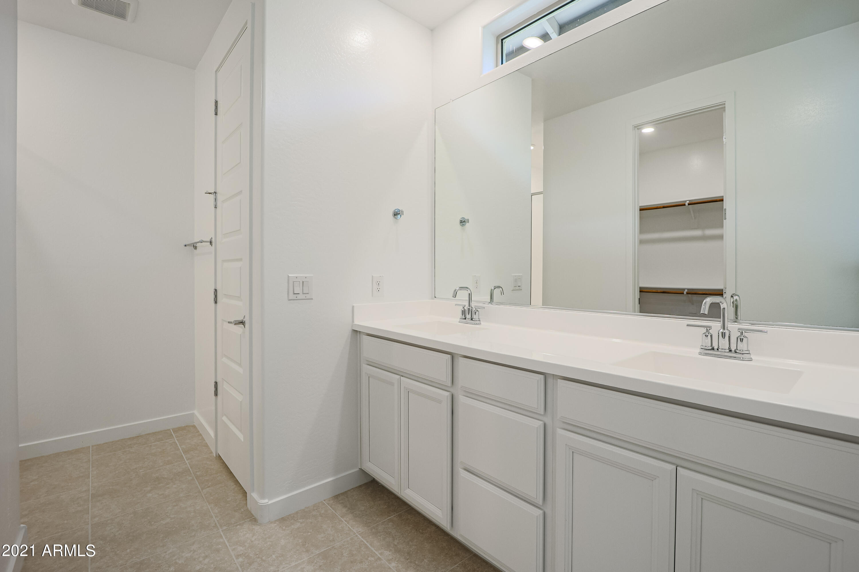 16556 West Alameda Road Surprise, AZ 85387 - Photo 28 of 34 a bathroom with 2 sink and a mirror