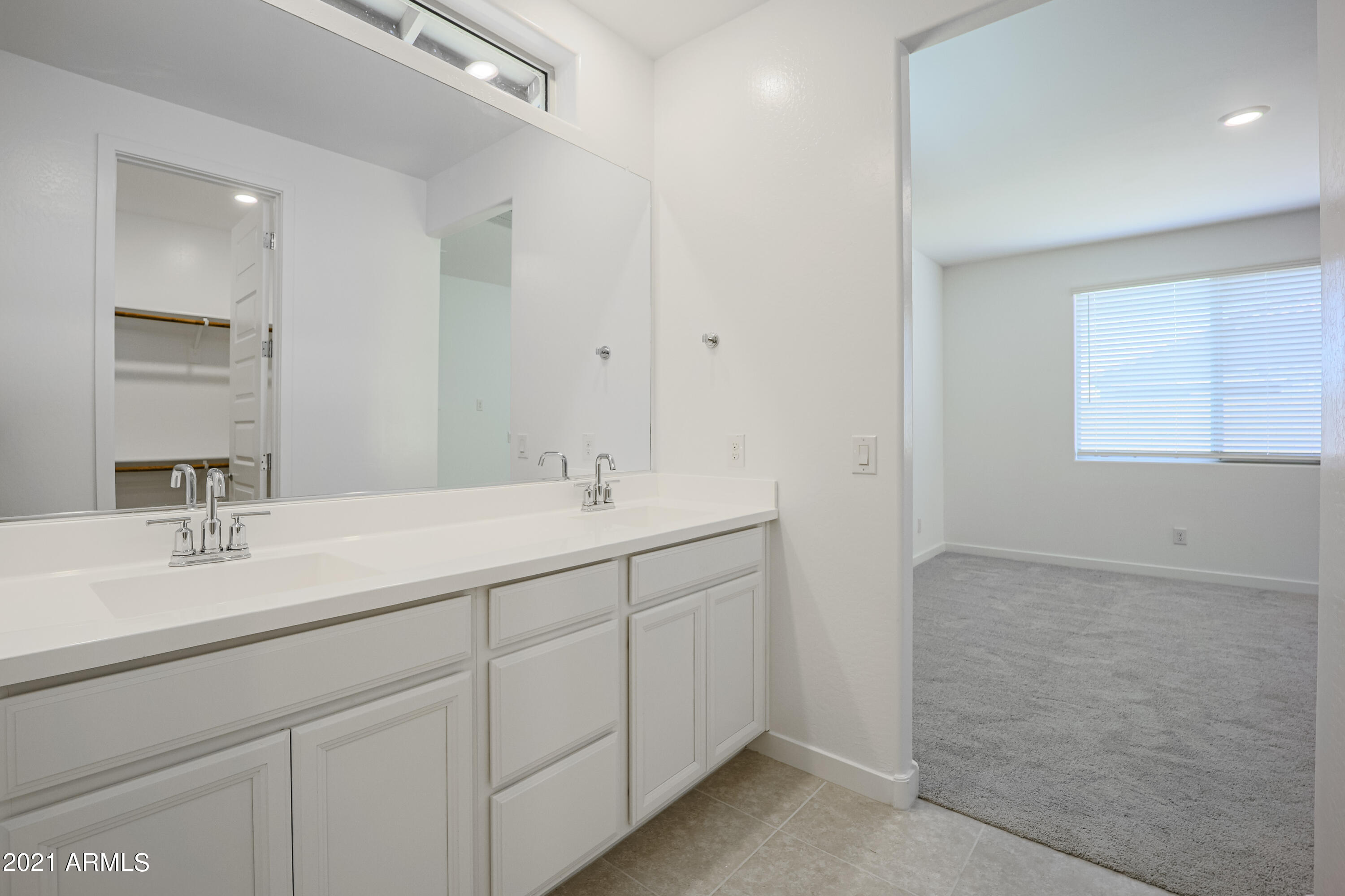 16556 West Alameda Road Surprise, AZ 85387 - Photo 29 of 34 a bathroom with 2 sink and a mirror