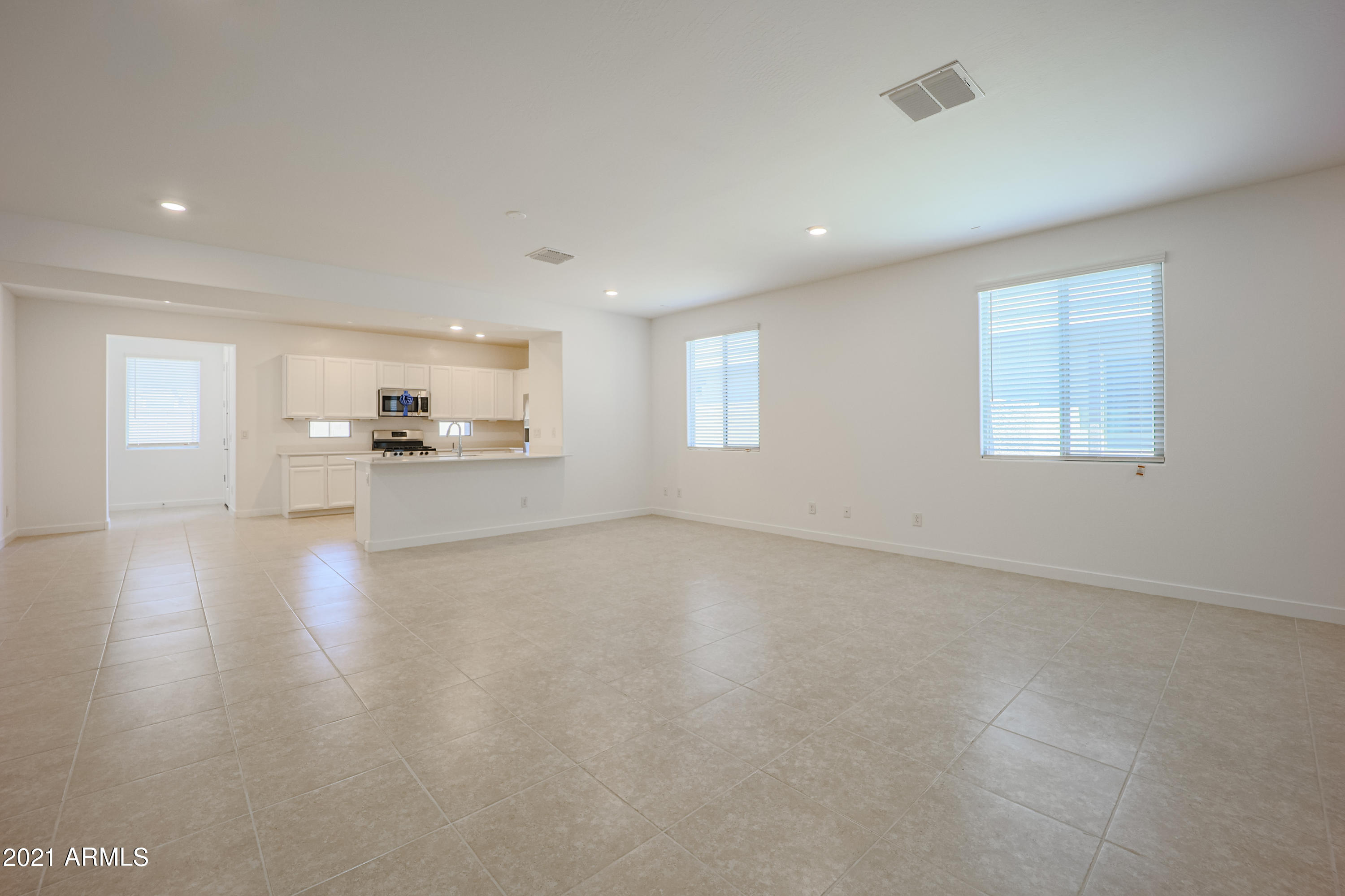 16556 West Alameda Road Surprise, AZ 85387 - Photo 4 of 34 a view of a kitchen with a sink stove cabinets and empty room