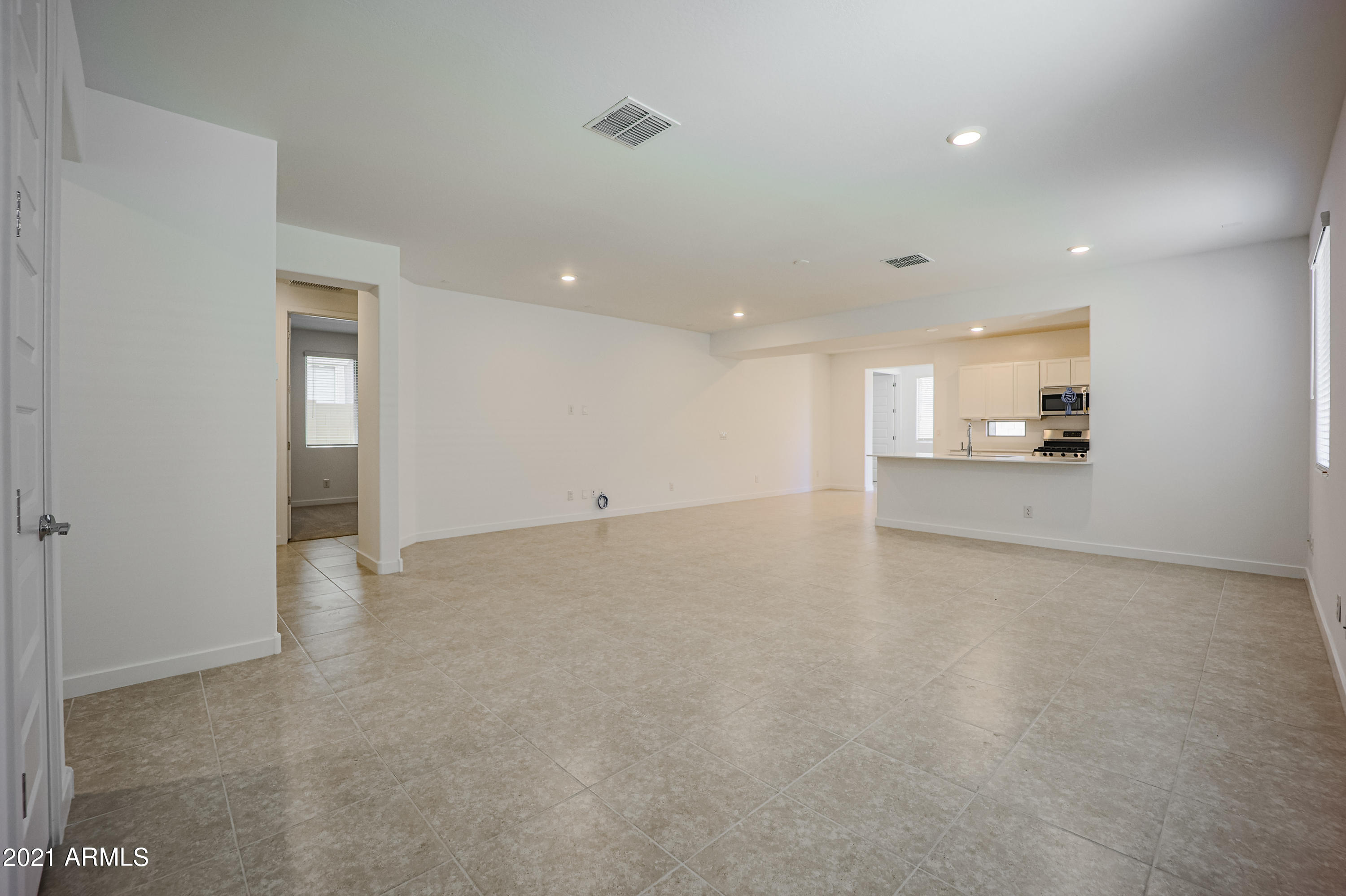 16556 West Alameda Road Surprise, AZ 85387 - Photo 5 of 34 an empty room with a kitchen and a sink