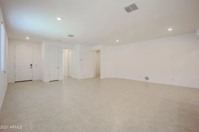 a kitchen with white cabinets and sink