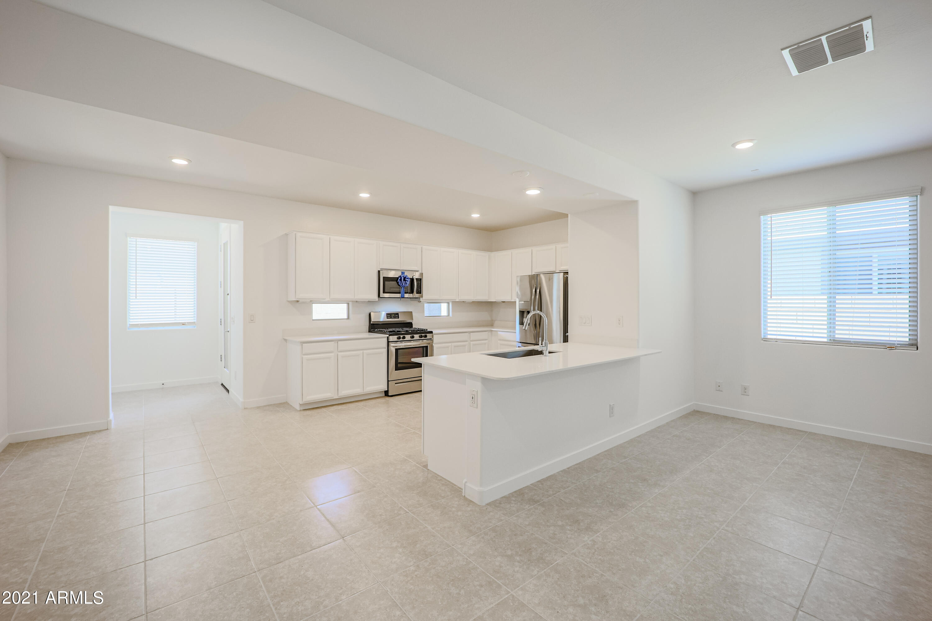 16556 West Alameda Road Surprise, AZ 85387 - Photo 9 of 34 a kitchen with white cabinets and sink
