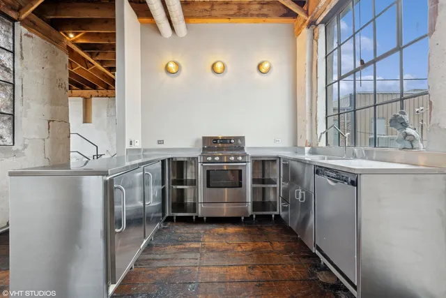 a spacious bedroom with a bed and a large window