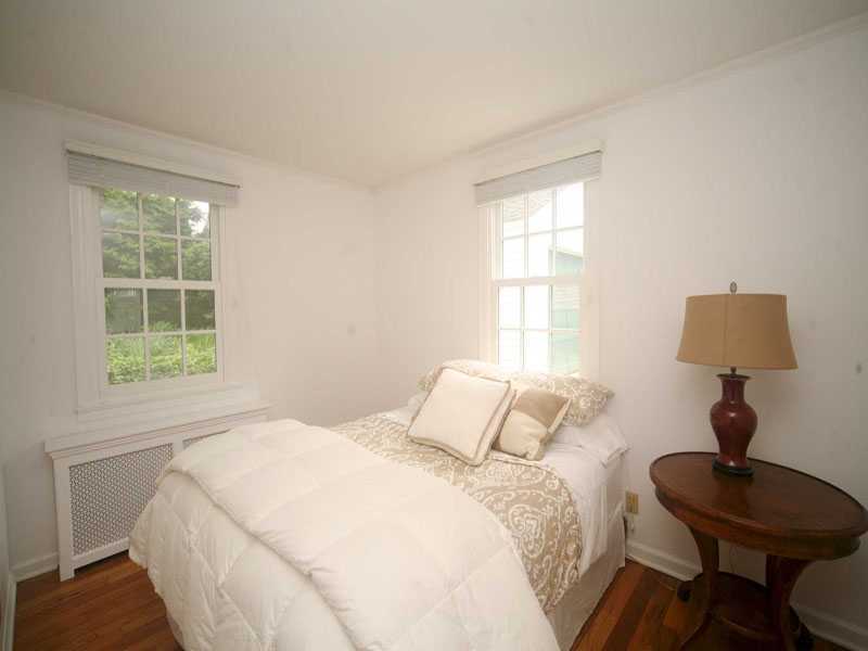 42 Walmsley Road Darien, CT 06820 - Photo 15 of 21 a bedroom with a bed window and a lamp