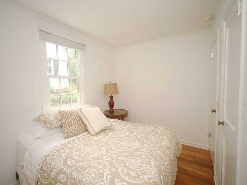 42 Walmsley Road Darien, CT 06820 - Photo 16 of 21 a bedroom with a bed and a window