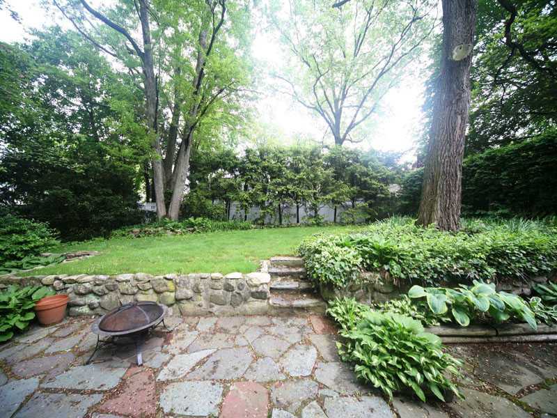 42 Walmsley Road Darien, CT 06820 - Photo 19 of 21 a view of a backyard with plants and a garden