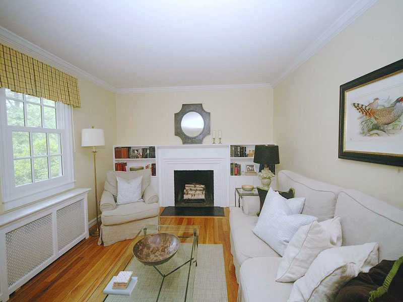 42 Walmsley Road Darien, CT 06820 - Photo 3 of 21 a living room with furniture a fireplace and a large window