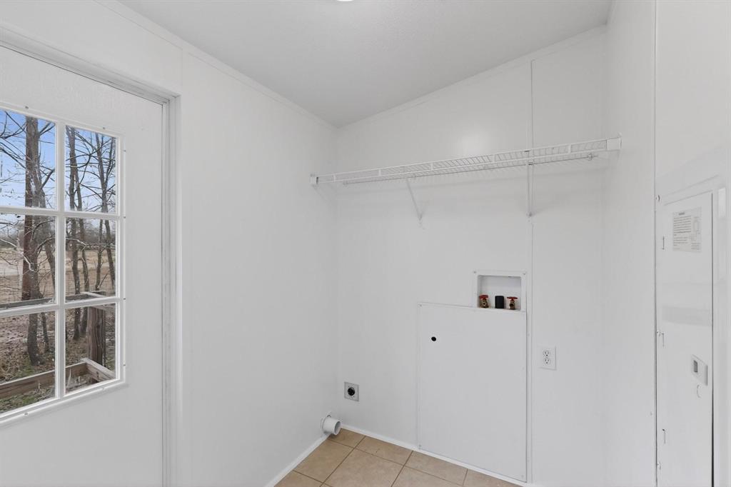 6553 Private Road 2270 Quinlan, TX 75474 - Photo 14 of 31 Laundry room featuring electric dryer hookup, washer hookup, and light tile patterned floors