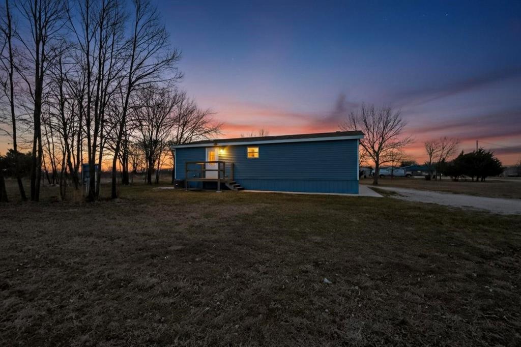6553 Private Road 2270 Quinlan, TX 75474 - Photo 28 of 31 Rear view of property featuring a wooden deck and a lawn