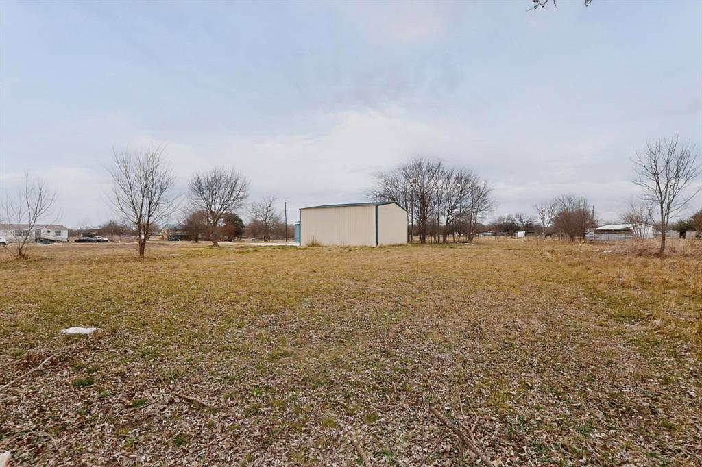 6553 Private Road 2270 Quinlan, TX 75474 - Photo 29 of 31 View of green lawn featuring an outbuilding and a pole building