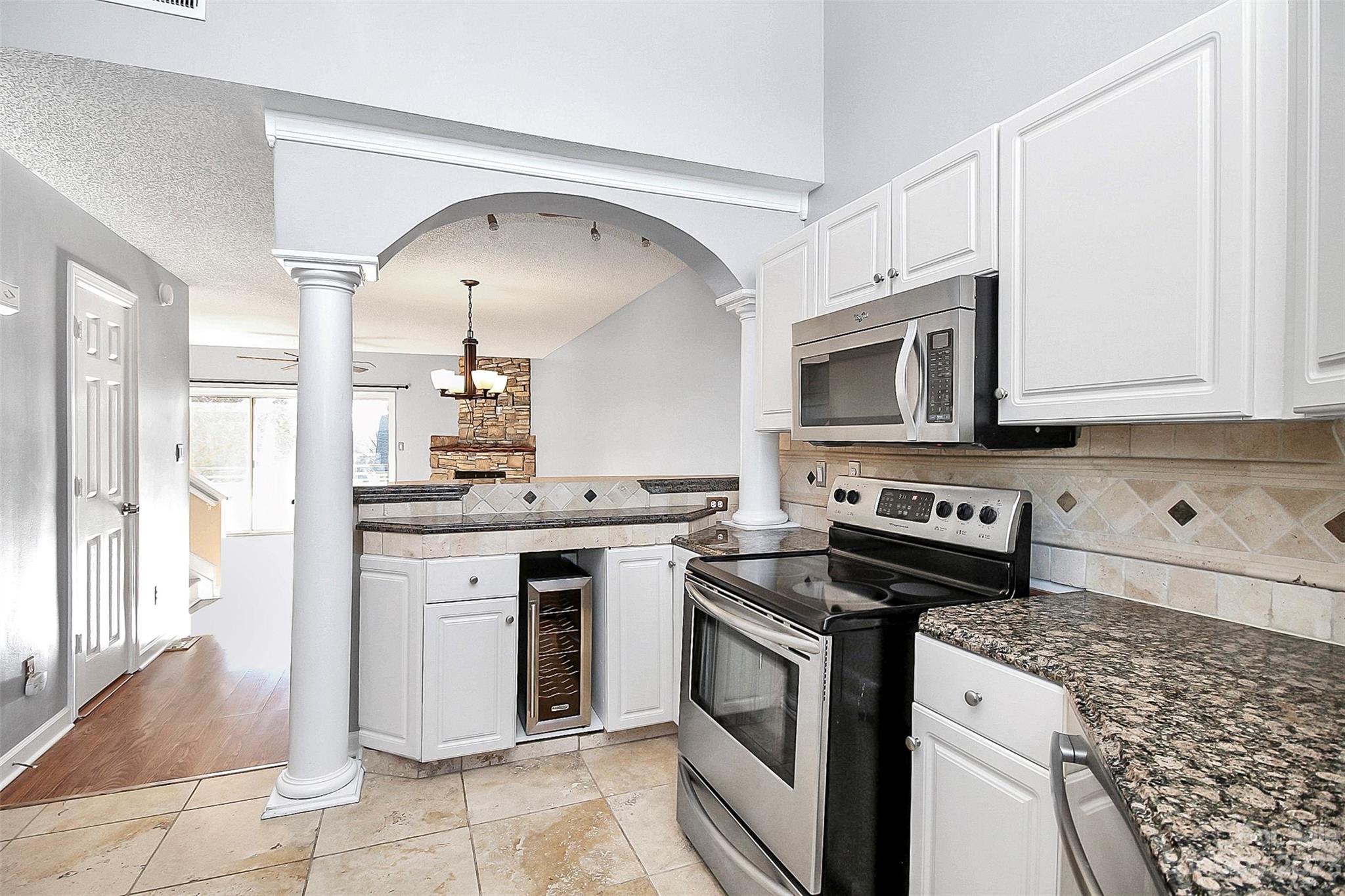 13932 Queens Harbor Road Charlotte, NC 28278 - Photo 18 of 42 a kitchen with stainless steel appliances granite countertop a stove and a microwave