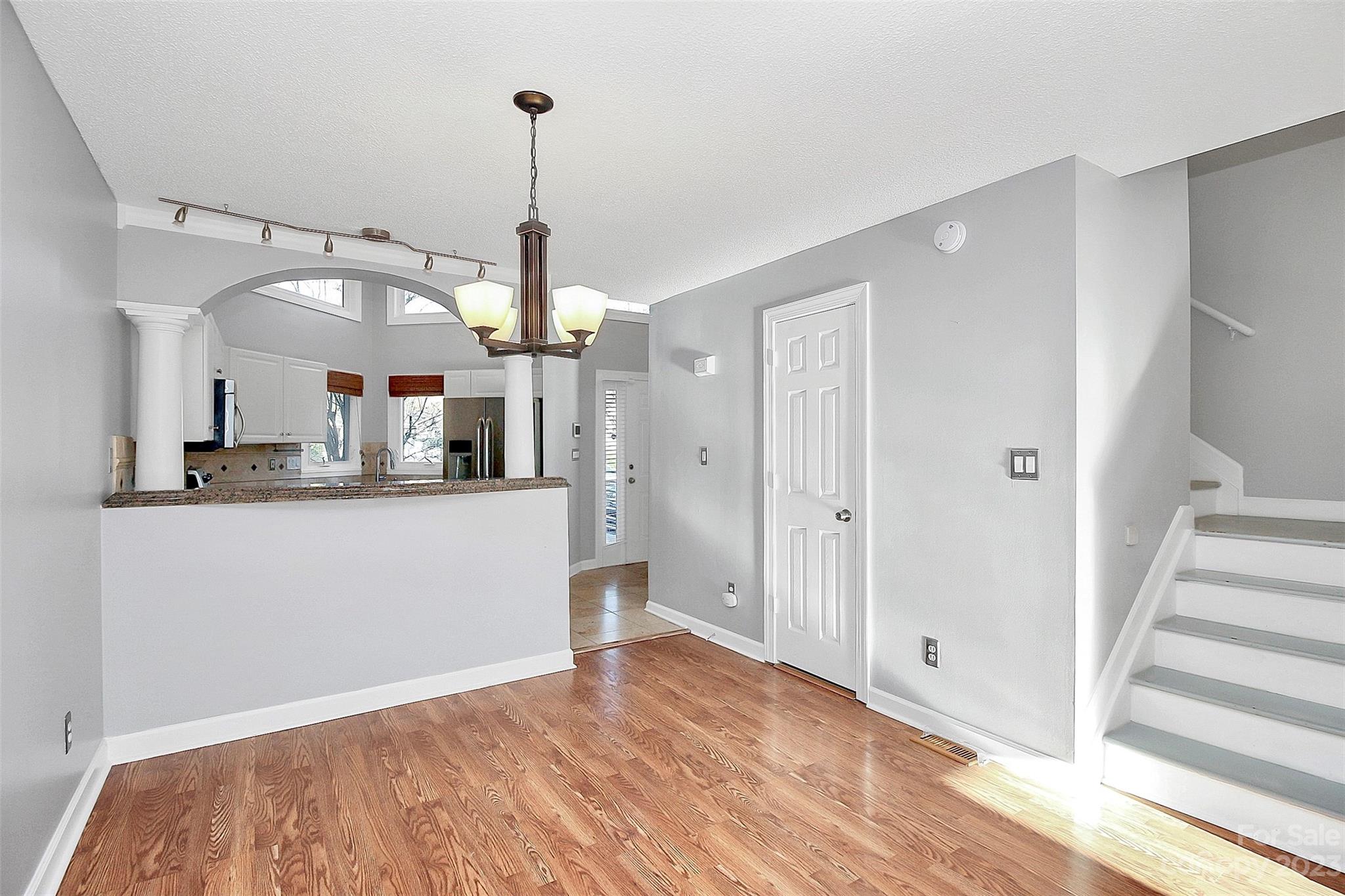 13932 Queens Harbor Road Charlotte, NC 28278 - Photo 22 of 42 a view of a kitchen with wooden floor and a ceiling fan