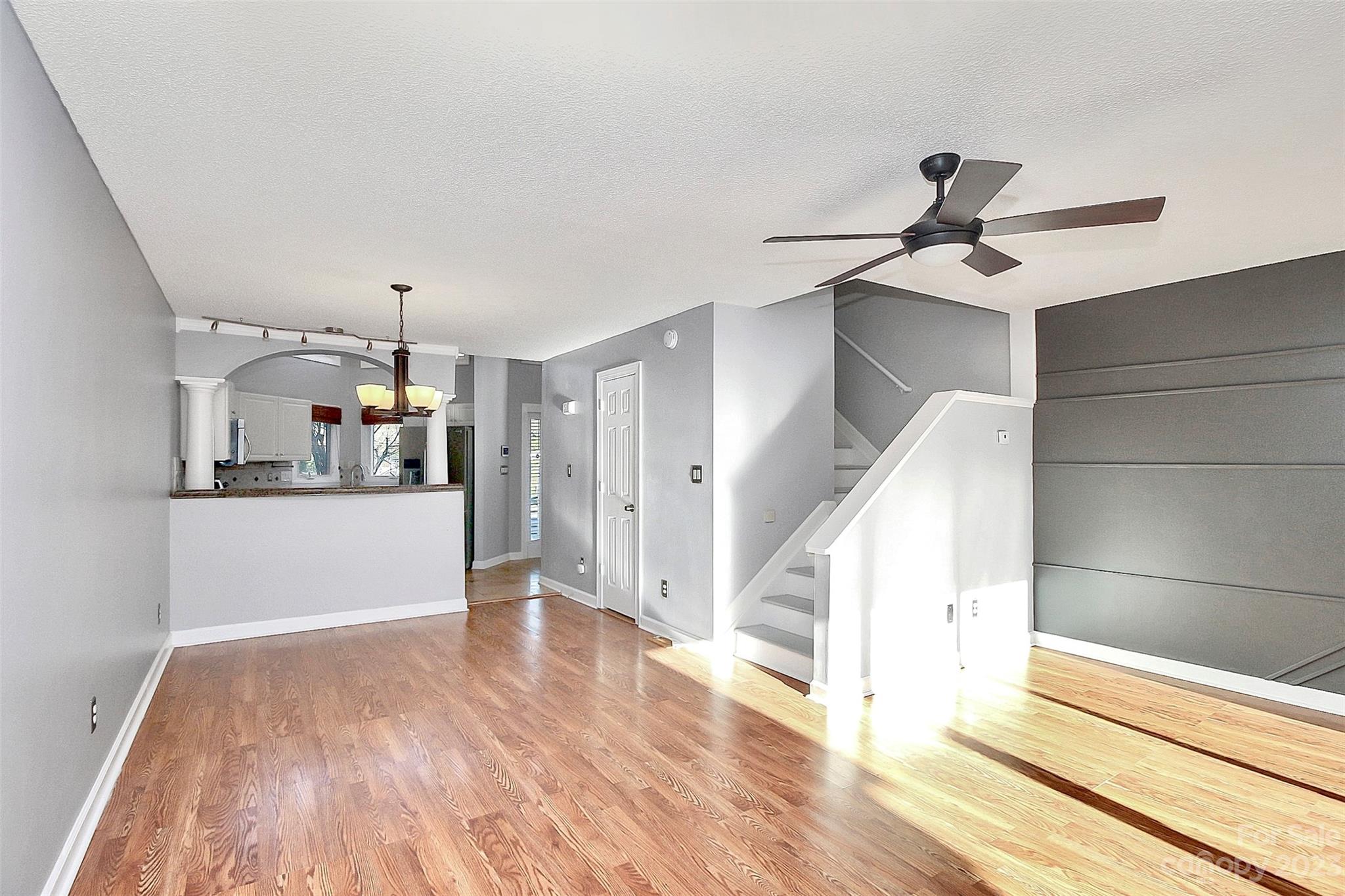 13932 Queens Harbor Road Charlotte, NC 28278 - Photo 25 of 42 a view of a kitchen with wooden floor and a ceiling fan