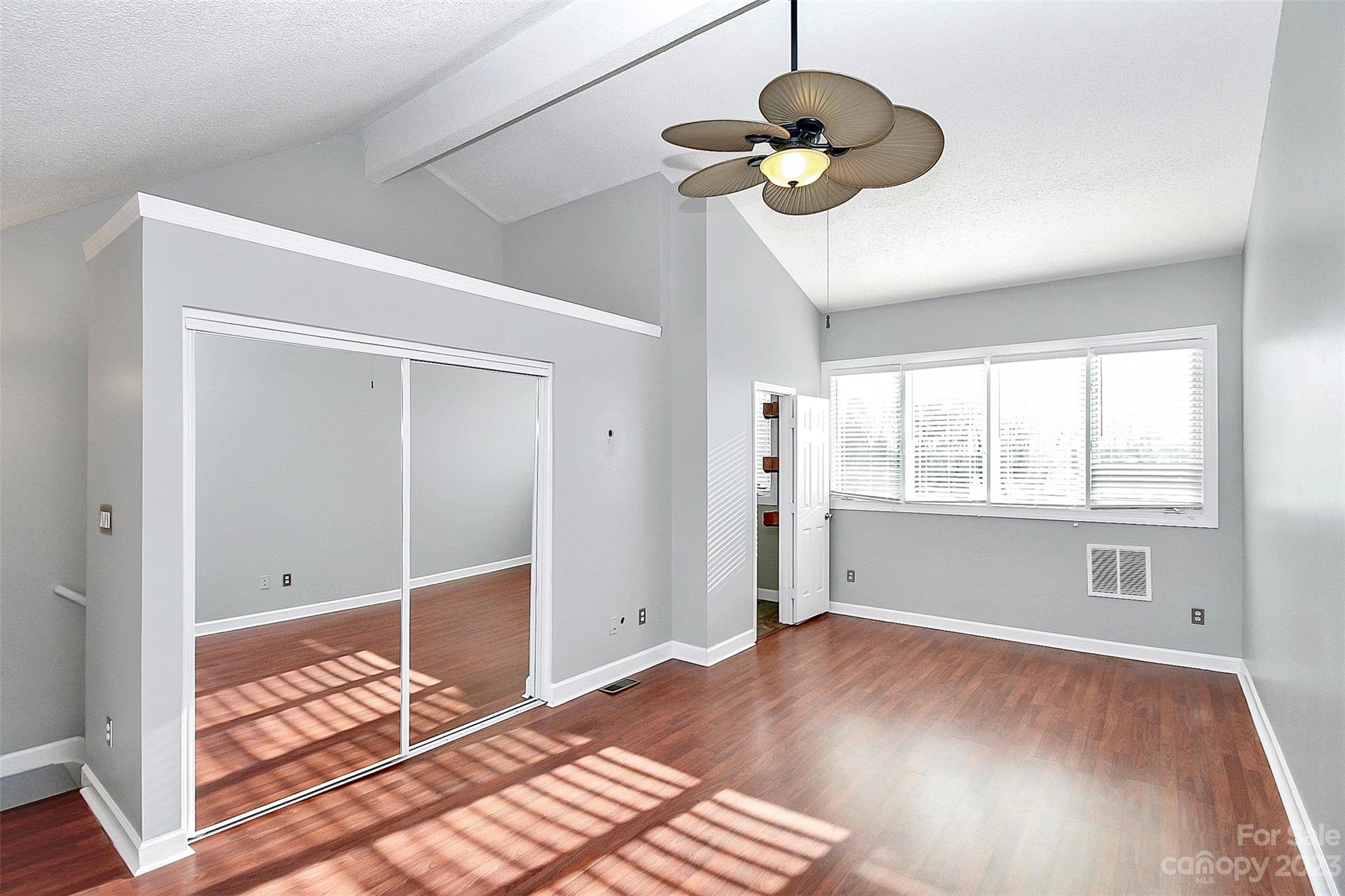 13932 Queens Harbor Road Charlotte, NC 28278 - Photo 27 of 42 a view of an empty room with wooden floor and a window