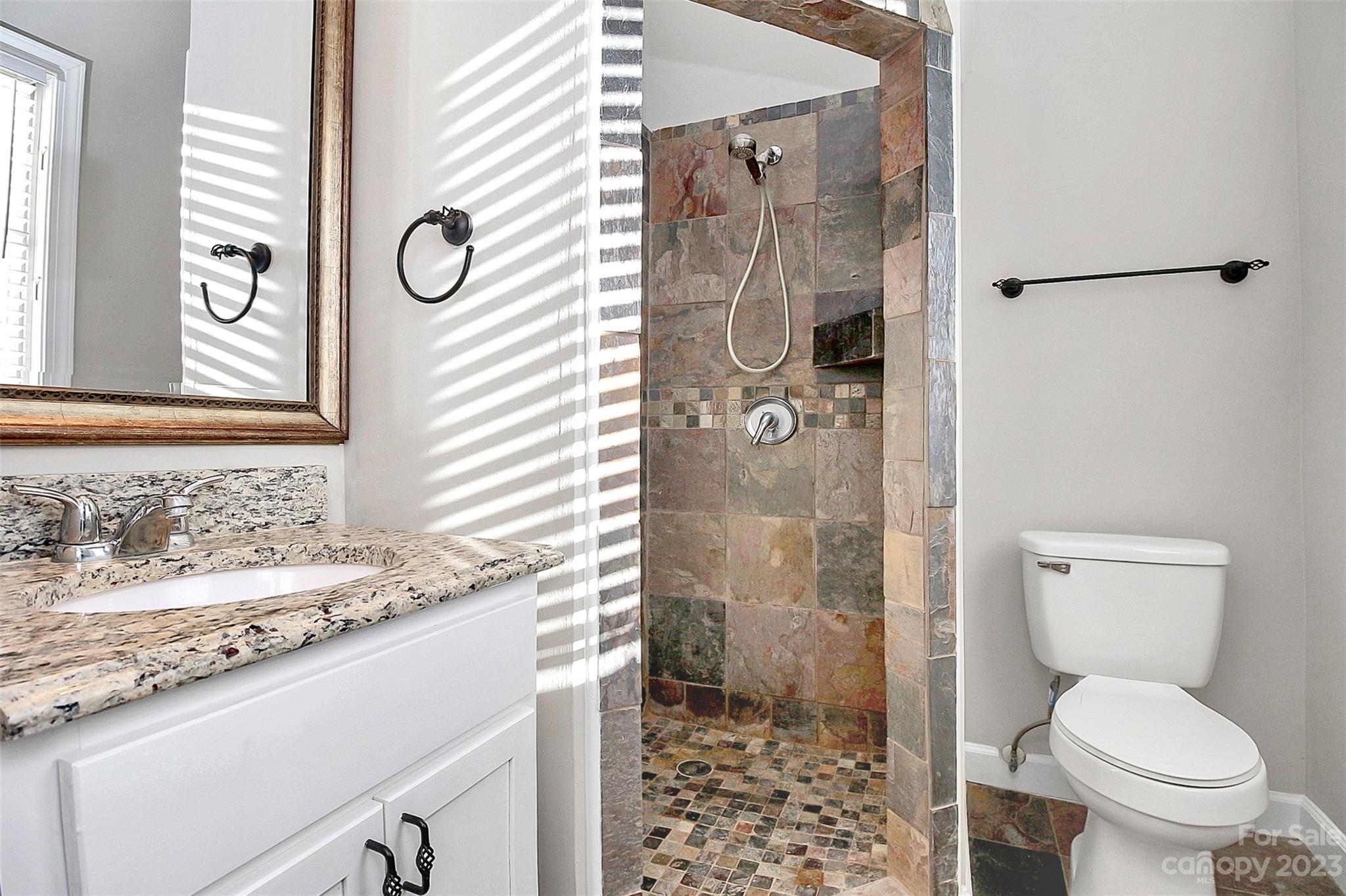 13932 Queens Harbor Road Charlotte, NC 28278 - Photo 29 of 42 a bathroom with a granite countertop sink toilet and shower