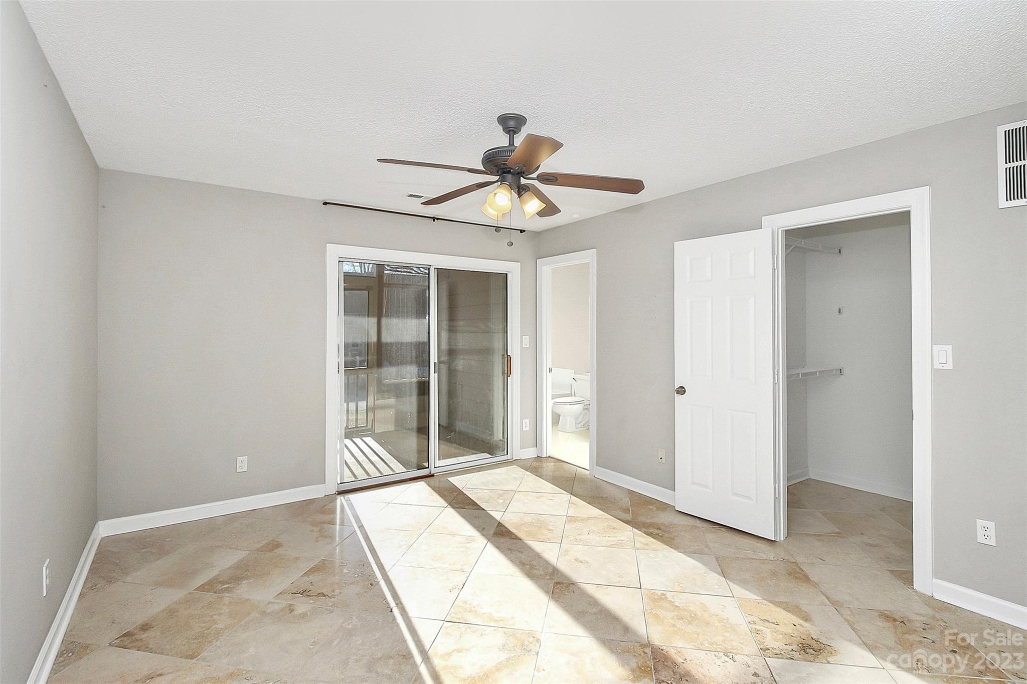 13932 Queens Harbor Road Charlotte, NC 28278 - Photo 6 of 42 a view of a livingroom with a chandelier fan and windows