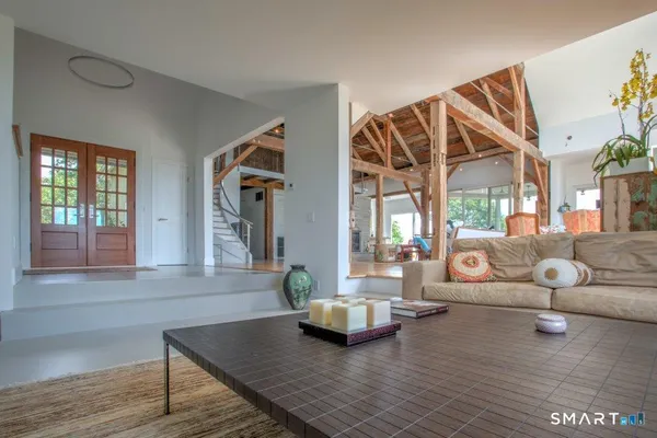 a living room with furniture and wooden floor
