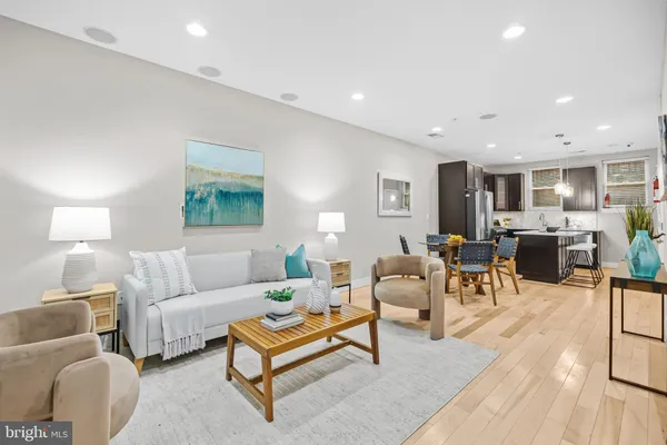 a living room with furniture a lamp and a table