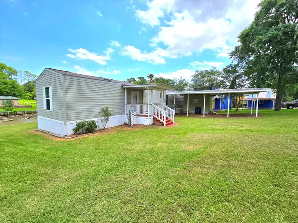 a view of a house with a backyard porch and sitting area