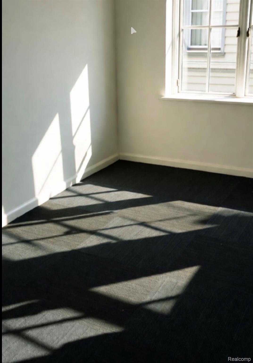 7084 Ranger Drive Romulus, MI 48174 - Photo 12 of 13 Empty room featuring baseboards and dark colored carpet