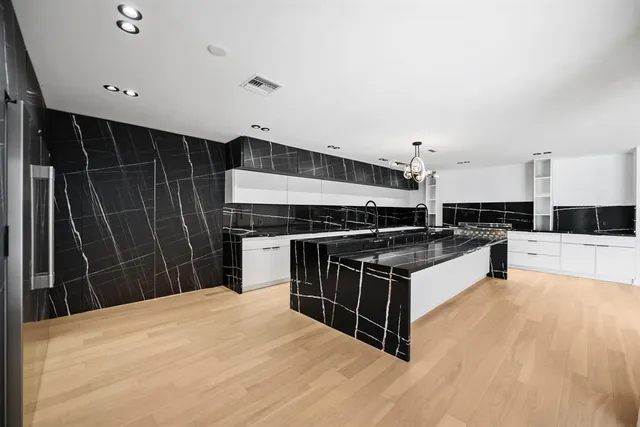 a kitchen with stainless steel appliances a stove and a refrigerator