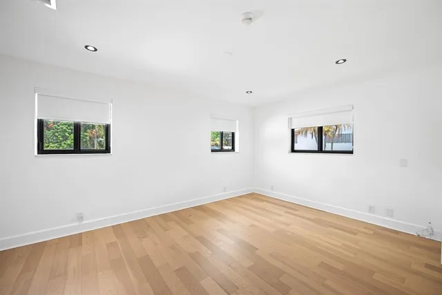 a view of a room with wooden floor and white walls